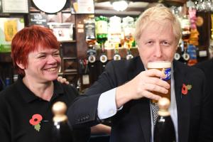 Boris Johnson drinking a pint at a pub