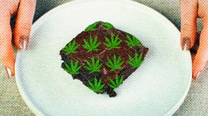 A woman holds a weed-infused brownie