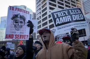 Demonstrators hold placards during a rally in protest of the killing of Amir Locke, outside the Hennepin County Government Center in Minneapolis, Minnesota on February 5, 2022. (KEREM YUCEL/AFP via Getty Images)