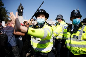 Protestors clash with Met Police officers during an Anti-Vax rally at Trafalgar Sqaure.