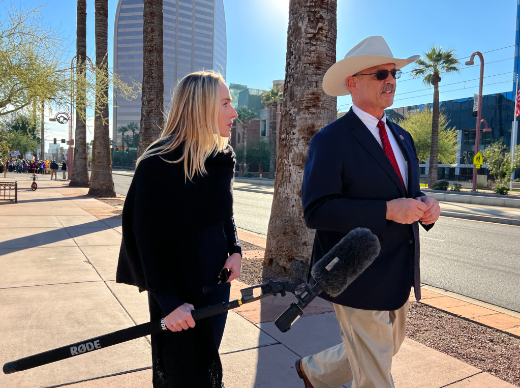 ​VICE News' Liz Landers (L) interviews Mark Finchem (R) about his run for secretary of state in Arizona.