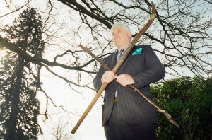 A police inspector holding the pitchfork murder weapons used to kill Charles Walton