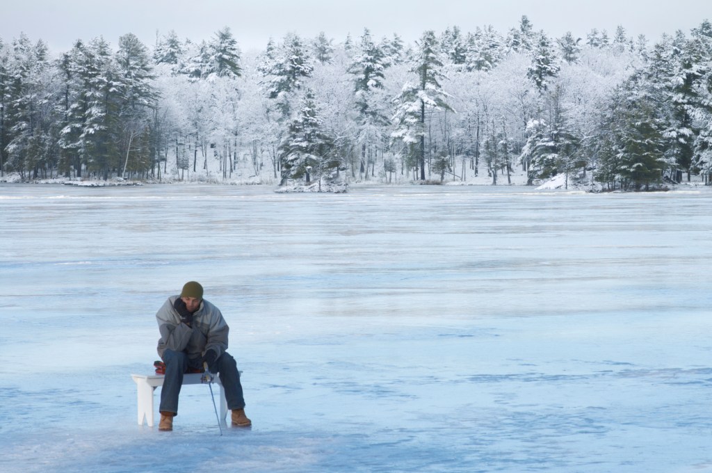 ​A man ice fishing. Getty Images