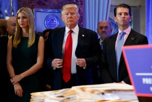 President-elect Donald Trump, center, stands next to daughter Ivanka and son Donald Trump Jr. at a news conference in the lobby of Trump Tower in New York, Jan. 11, 2017.