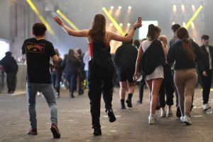 A raver in Liverpool with her arms outstretched.