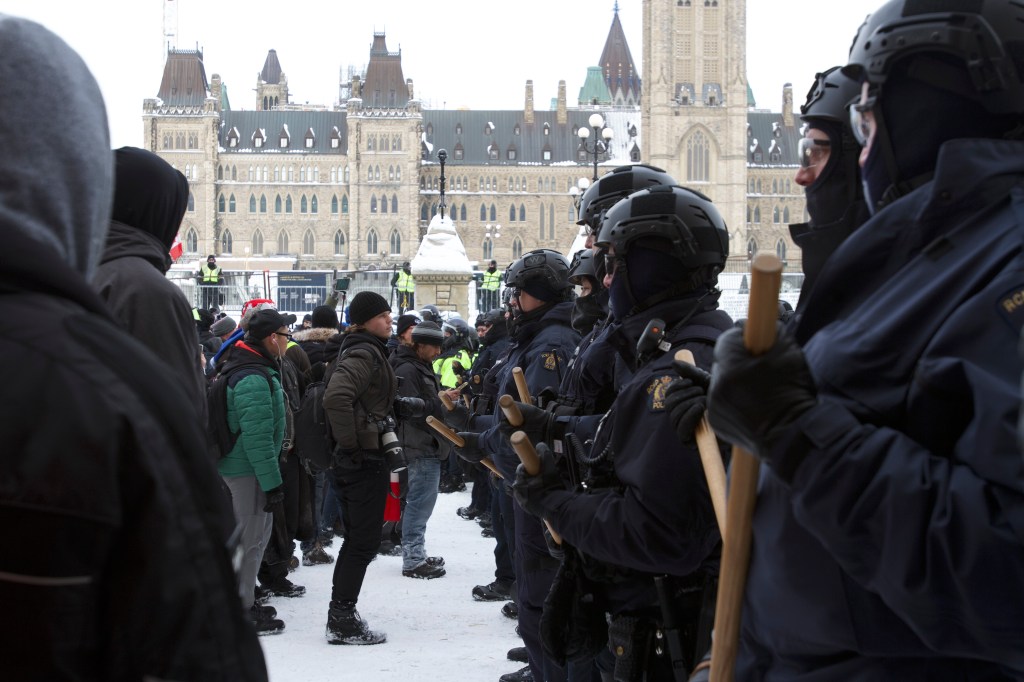 Protestors and cops face off in front of Canada's Parliament.