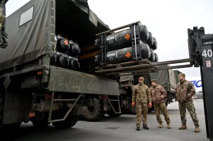 Ukrainian servicemen load a truck with the FGM-148 Javelin, American man-portable anti-tank missile provided by US to Ukraine as part of a military support, upon its delivery at Kyiv's airport Boryspil on February 11,2022