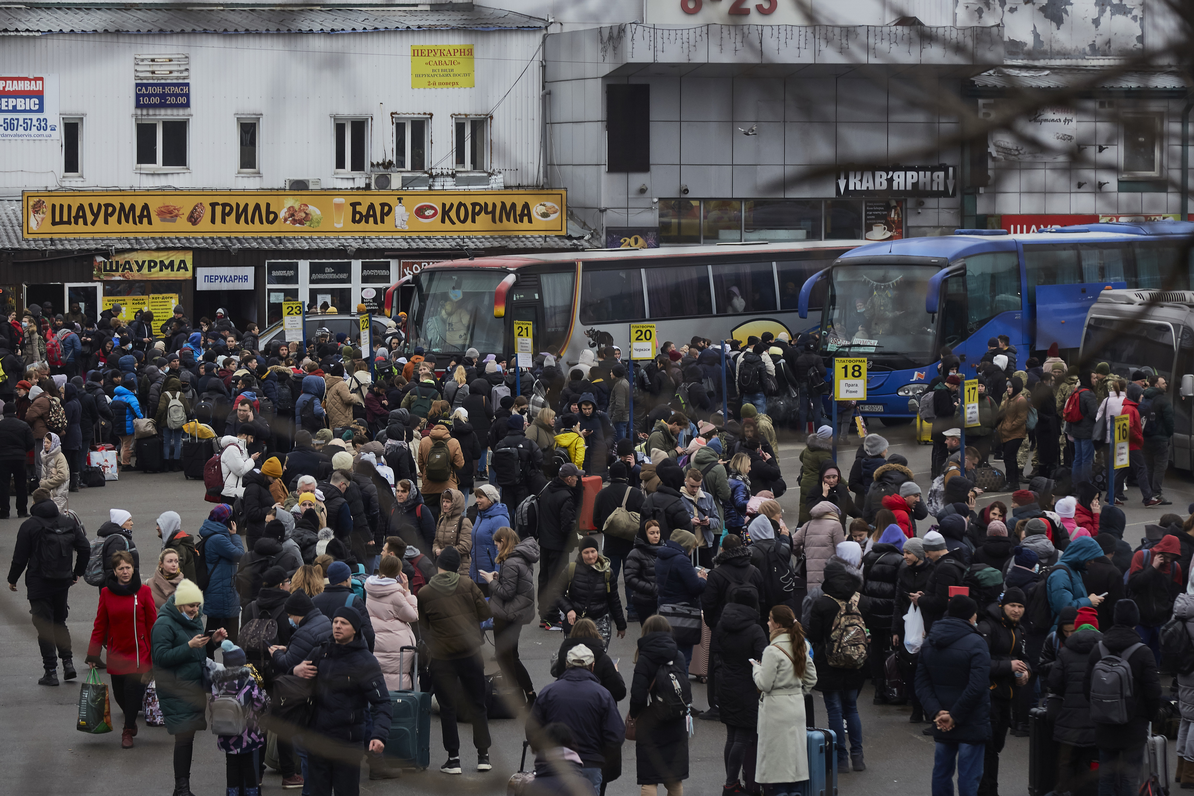 People wait for buses at a bus station as they attempt to evacuate the city on February 24, 2022 in Kyiv, Ukraine.