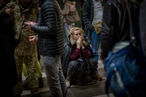 A woman reacts as she waits for a train trying to leave Kyiv, Ukraine, Thursday, Feb. 24, 2022. (AP Photo/Emilio Morenatti)