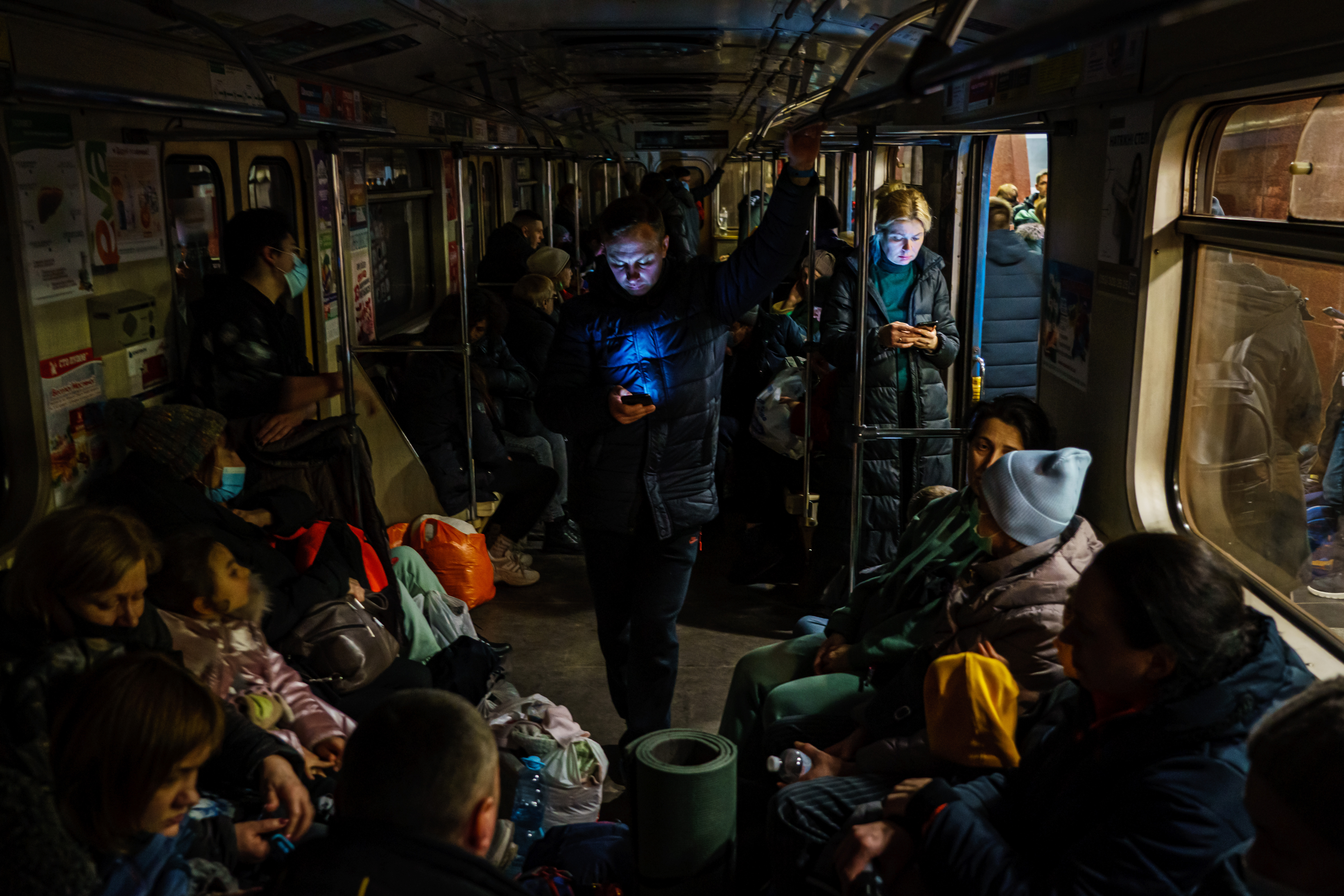 Hundreds of people seek shelter underground, on the platform, inside the dark train cars, and even in the emergency exits, in metro subway station as the Russian invasion of Ukraine continues, in Kharkiv, Ukraine, Thursday, Feb. 24, 2022.