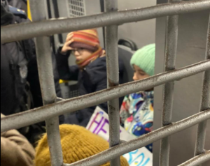 ​Children wait in the back of a police van.