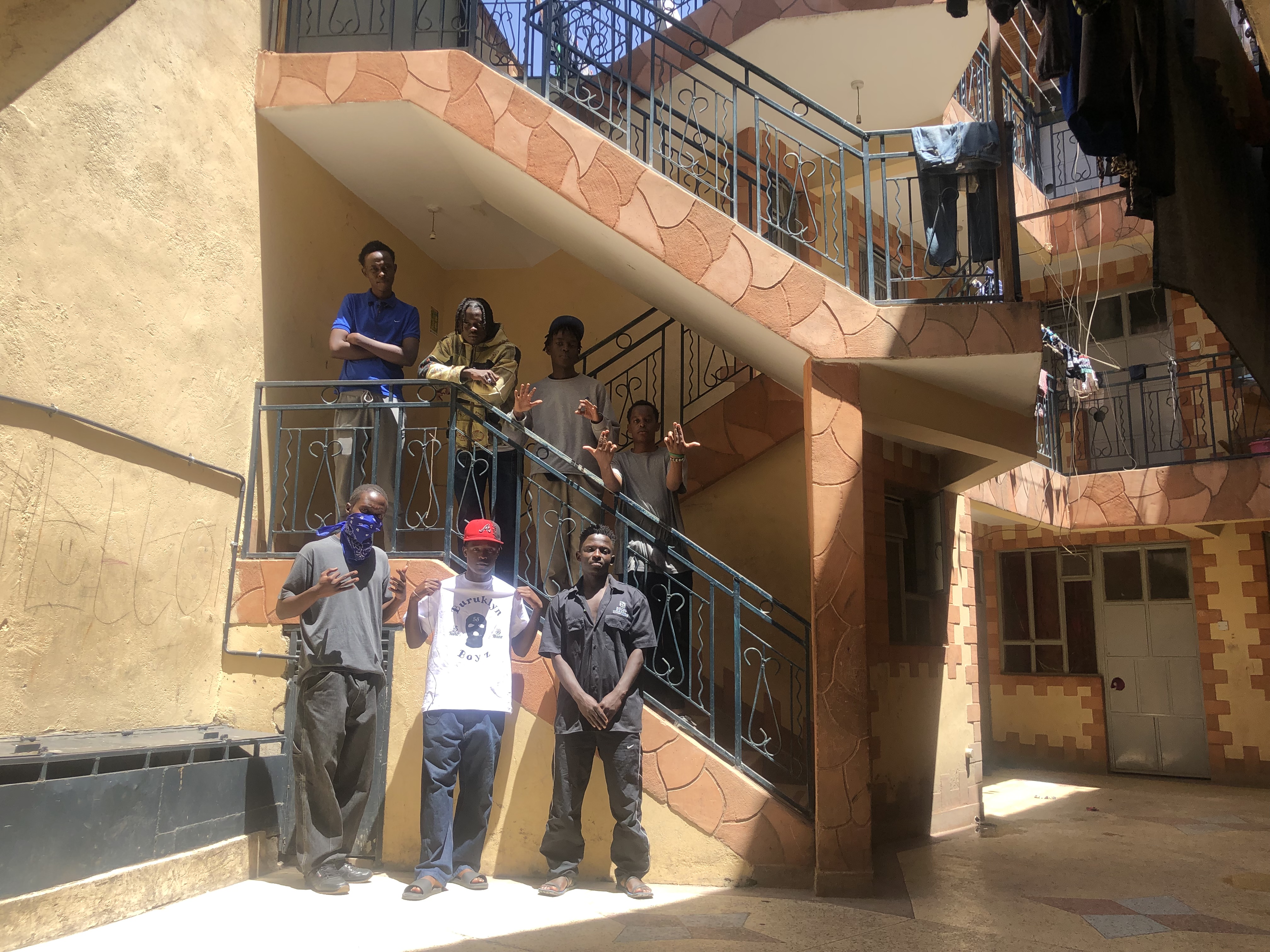 Kenyan drill crew Buruklyn Boyz standing on a staircase in Nairobi.