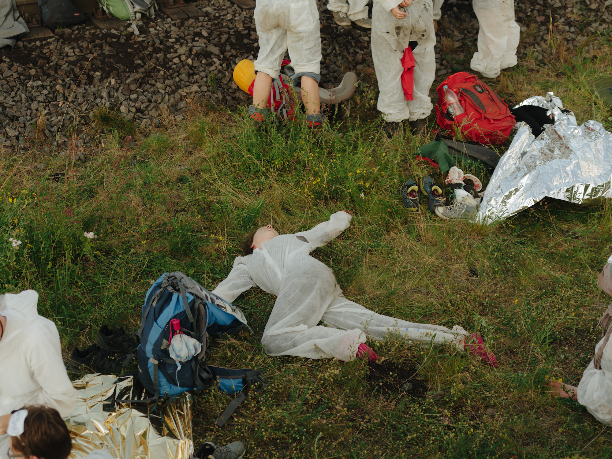 Ende Gelände environmental protesters lying on grass in North Rhine-Westphalia, Germany