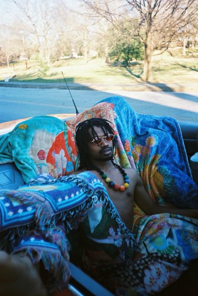 atlanta musician and rapper raury sitting in a blue car