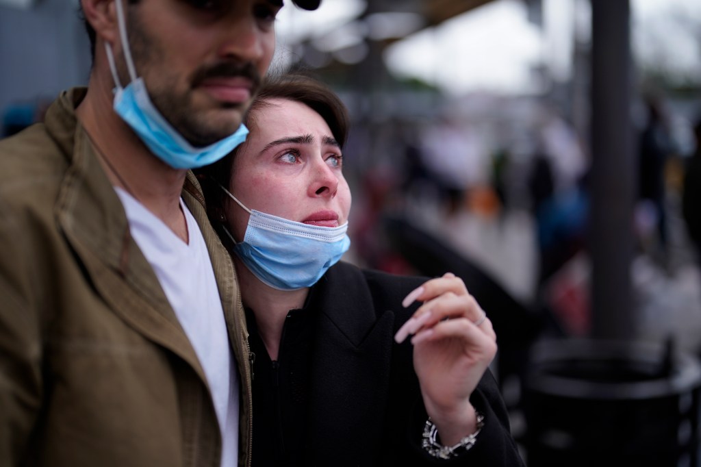 A woman from Ukraine stands at the U.S. border in Tijuana, Mexico, with her U.S. fiance as she waits to ask for asylum on March 10, 2022.