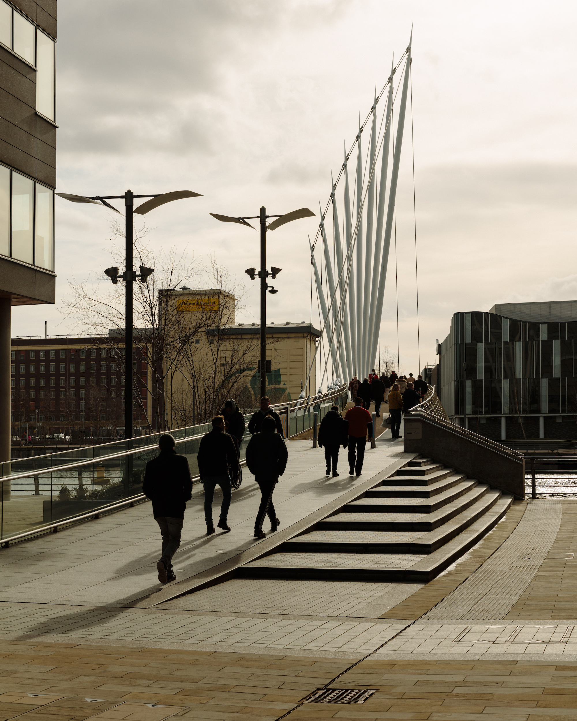 Manchester United fans cross the Media City Footbridge on the way to the ground