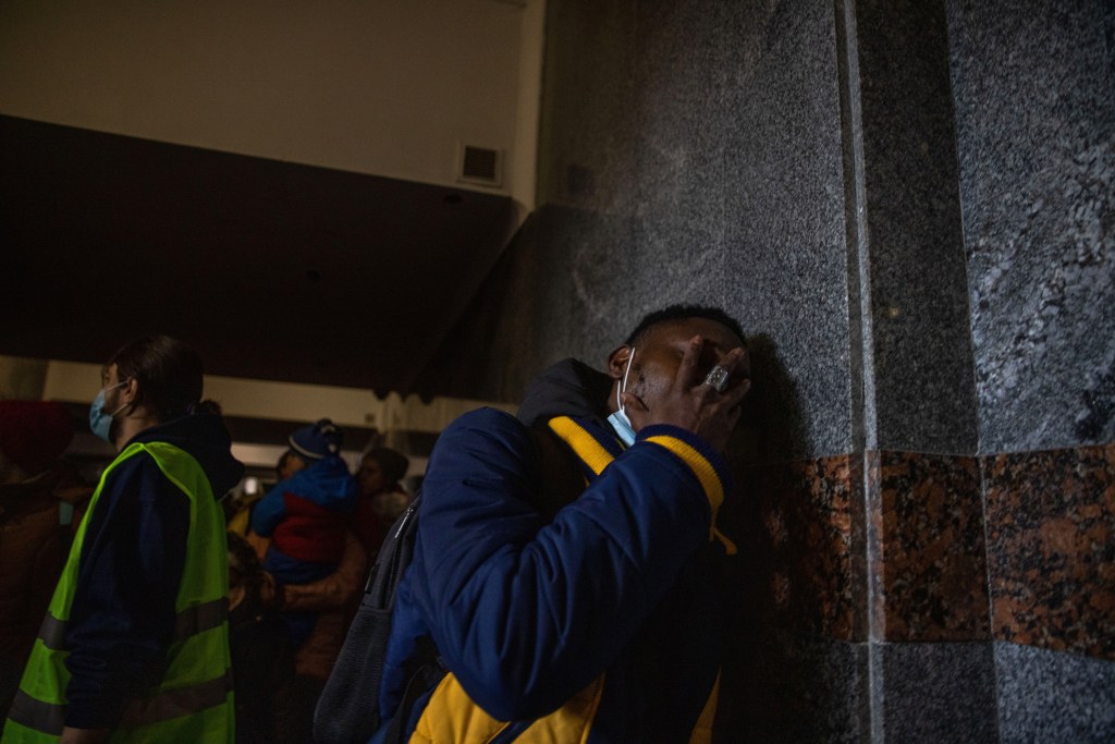 A Nigerian student cries after police refused to let him board a train to Poland, after six days of being turned away, at the Lviv-Holovnyi railway station in Lviv, Ukraine