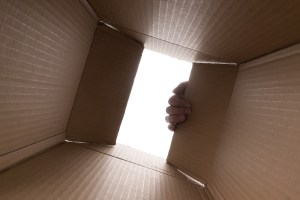 ​A hand opening a box. Getty Images