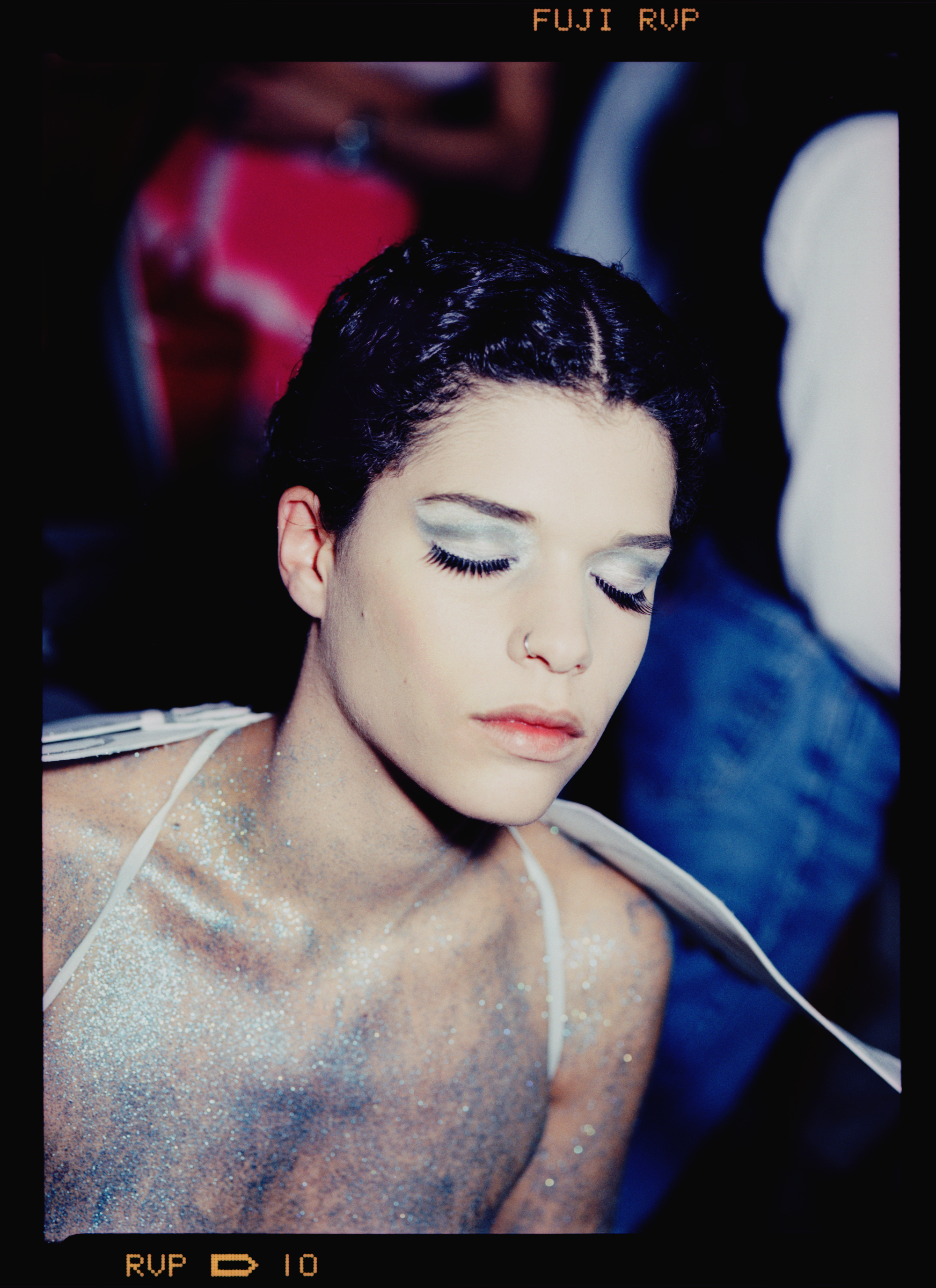 A clubber drenched in silver glitter at a rave in Zurich in the 90s