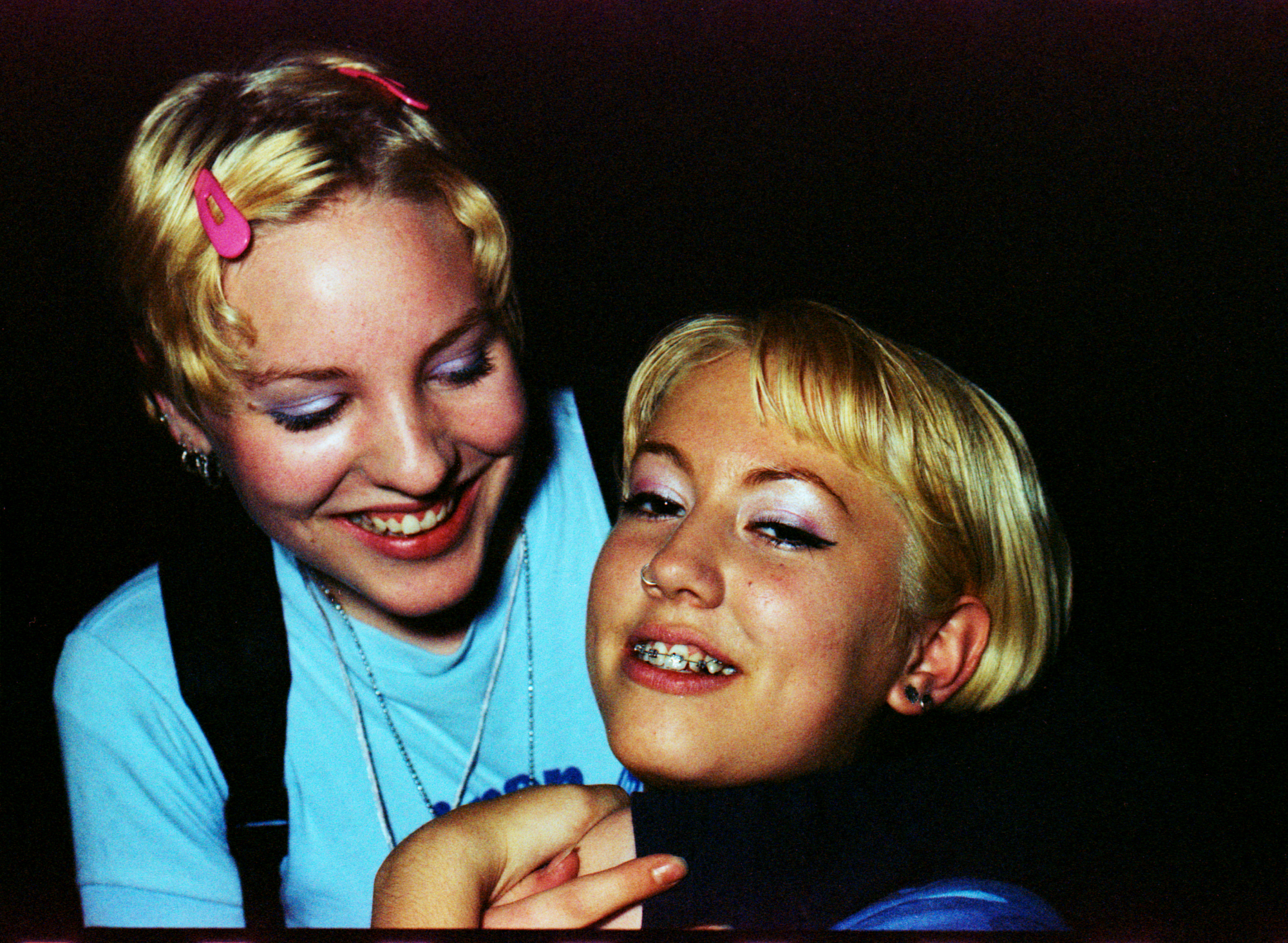 Two ravers smiling with 90s eyeshadow at a rave in Zurich