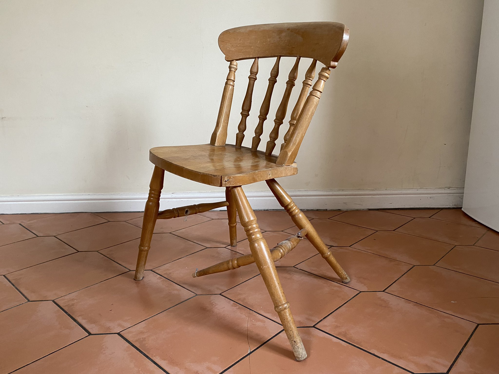 A landlord-repaired chair that is still broken.