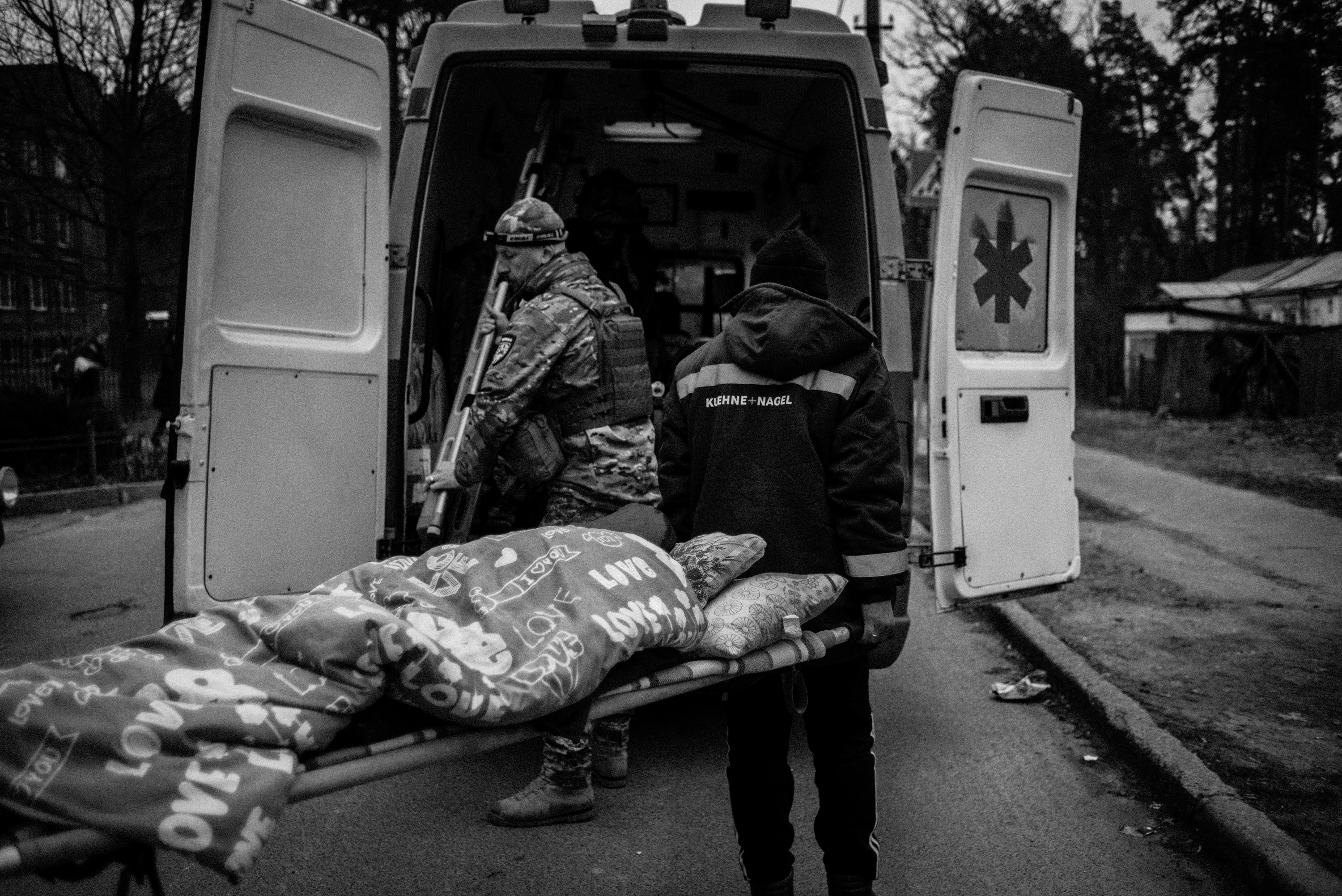 Medics evacuate a disabled woman from an area hit by heavy shelling.