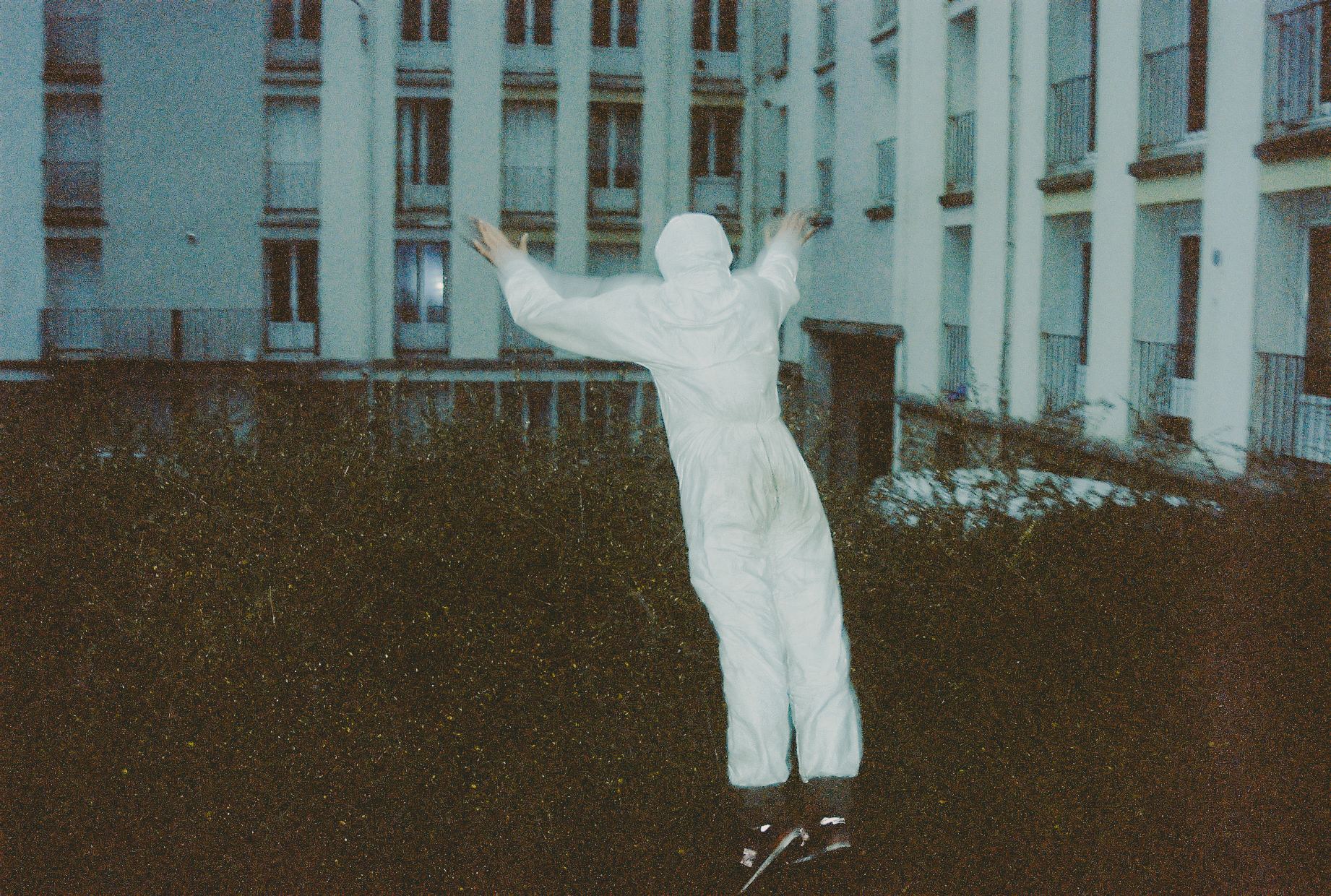 Mushary, France, hobbies – Photograph of a man in a white boiler suit jumping off a railing in mid-air