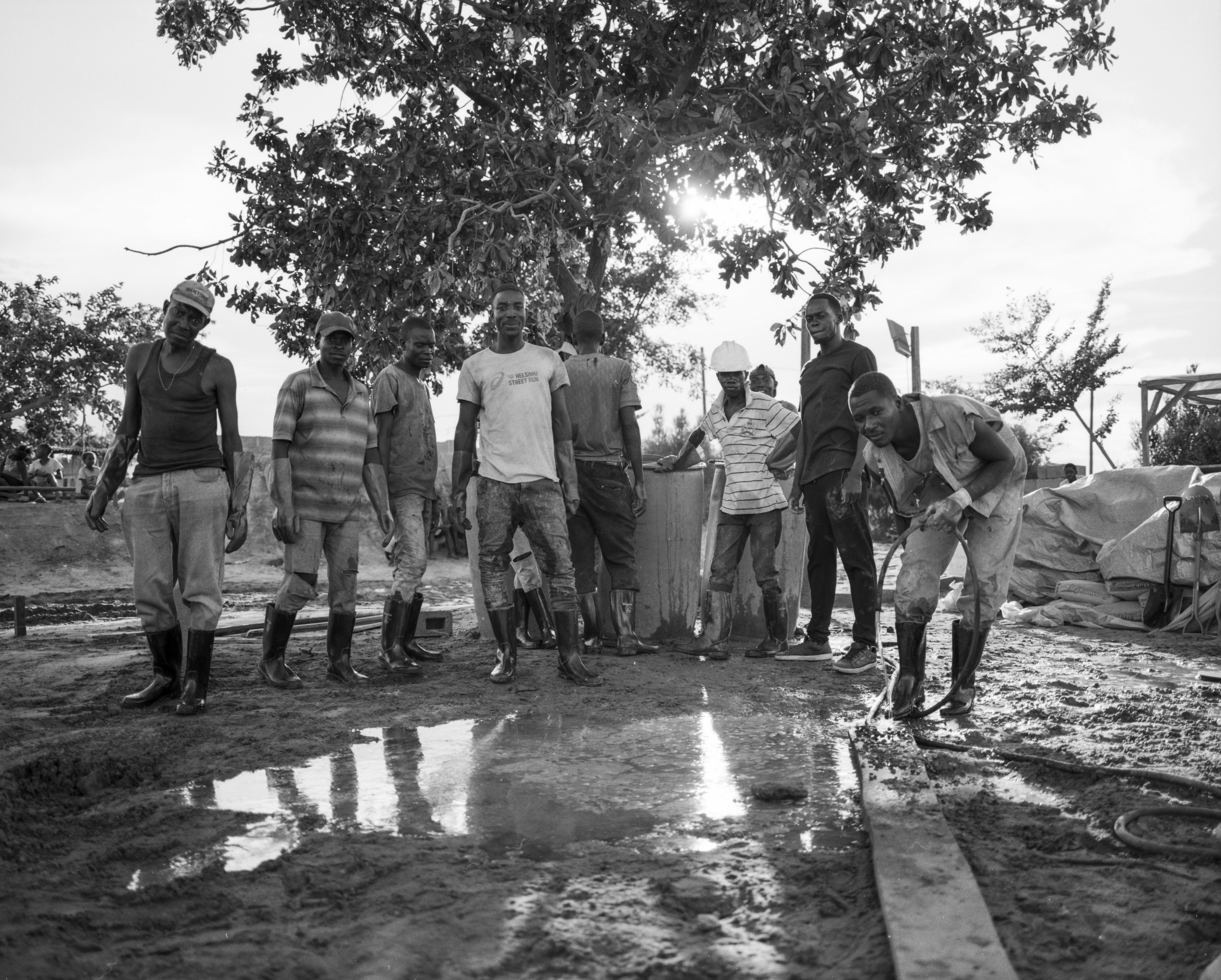 Africa, skateboarding, Jonas Camps - Black and white photo of a group of men proudly looking at the camera.