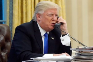 President Donald Trump speaks on the phone with Australian Prime Minister Malcolm Turnbull in the Oval Office of the White House in Washington, Jan. 28, 2017. (AP Photo/Alex Brandon)