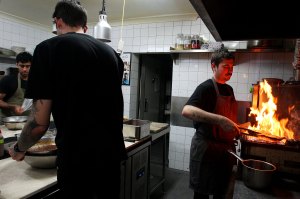 A chef cooking in a busy restaurant