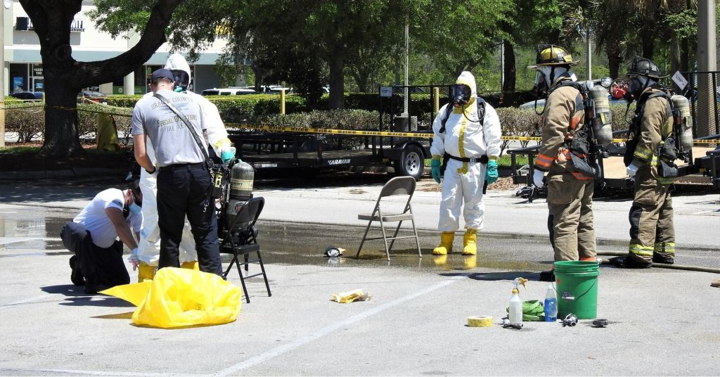 First responders in Orange County, California wearing white andy yellow hazmat suits.