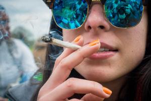 A woman smokes a spliff at 420 Pro Cannabis Rally in London's Hyde Park