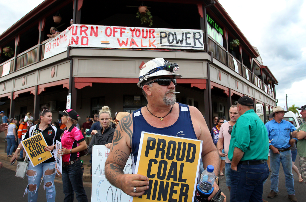 A protester holding a "Proud Coal Min