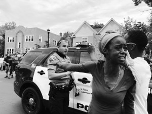 A woman outraged by the killing of George Floyd speaks to a crowd and blocks a police officer’s vehicle in Minneapolis, Minnesota, May 26, 2020.