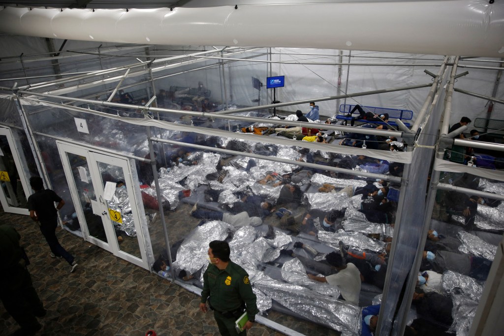 Young minors lie inside a pod at a holding facility run by the US Customs and Border Protection.