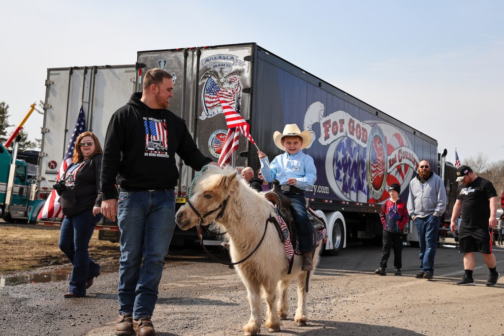 A kid rides on a pony as 'The People's Convoy' parked at the Speedway in Hagerstown of Maryland, United States on March 5, 2022 as they are planned head to nation's capital.