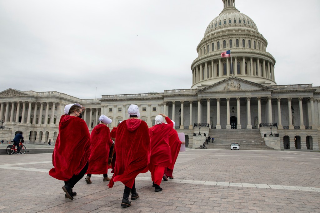 People dressed in costumes from the "Handmaid's Tale" walk to the U.S. Capitol building during an abortion rights protest in Washington on Sunday.