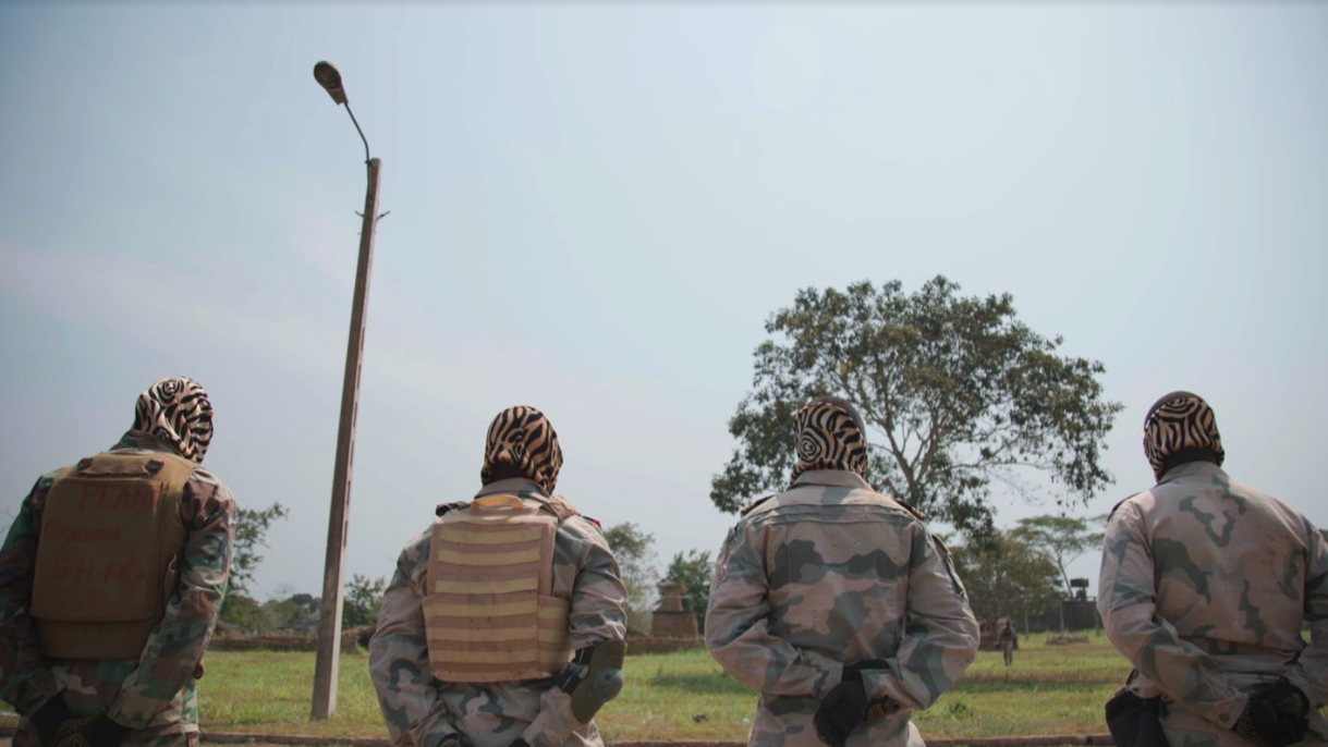 Four Central African soldiers pictured from behind during field training with Russian contractors in Berengo