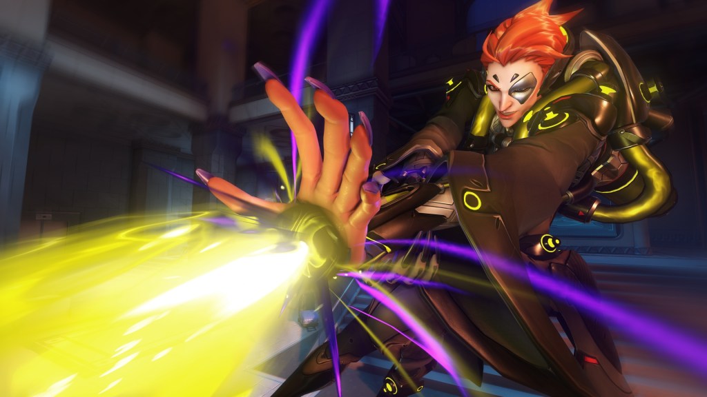 Moira fires abeam of purple and yellow energy out of her hands, healing allies and hurting enemies.