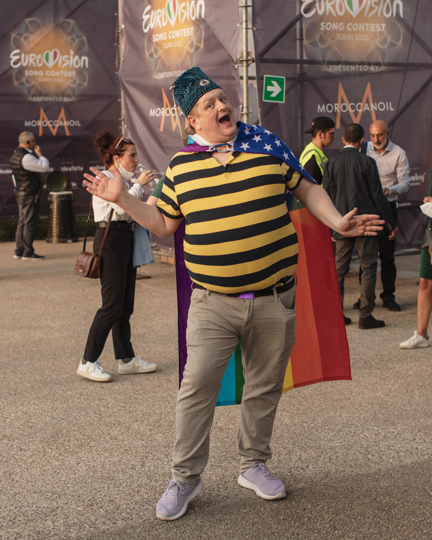 A Eurovision 2022 fan in Turin in a rainbow flag