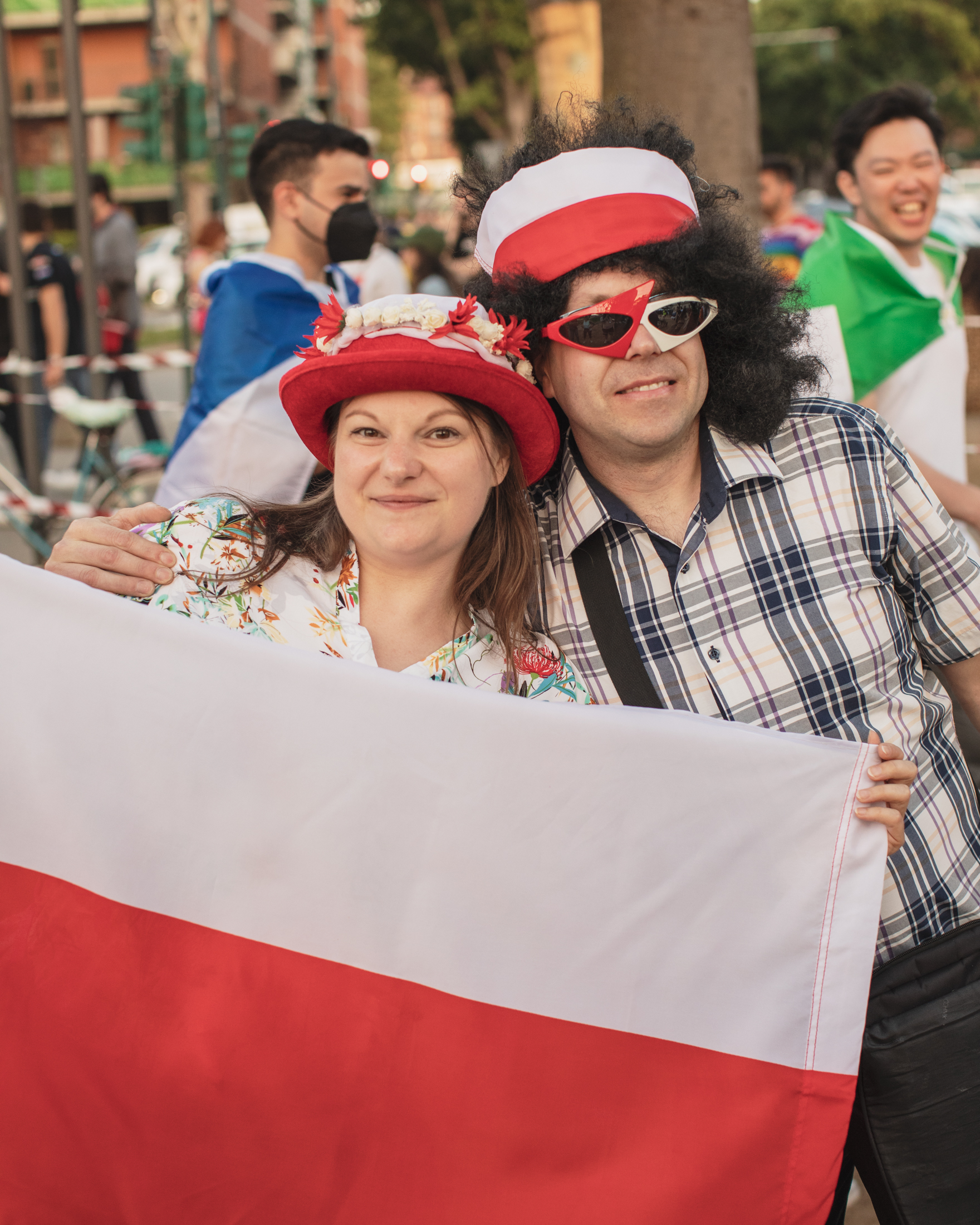 Two Eurovision 2022 fan ins Turin holding up Polish flag