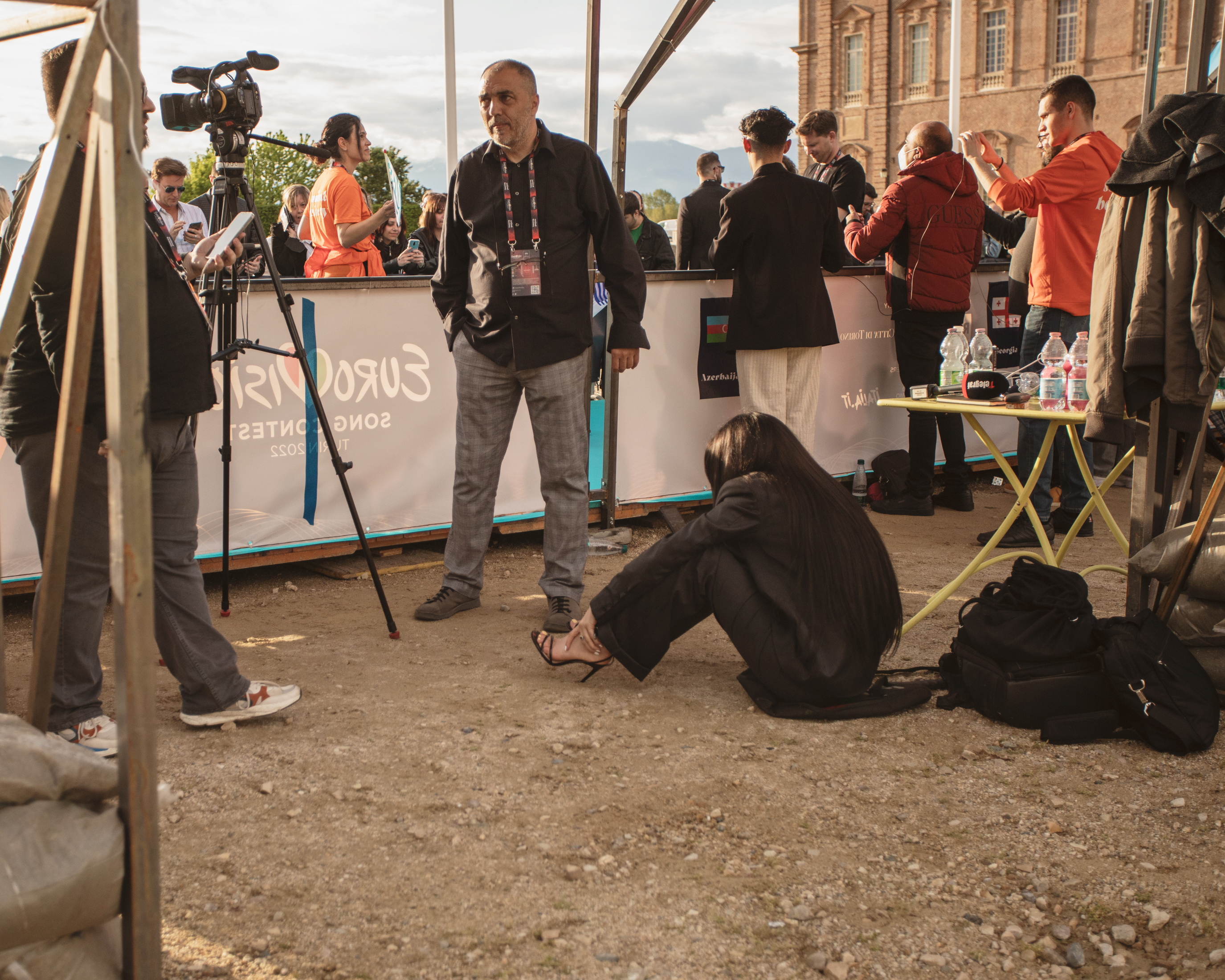 Eurovision 2022 in Turin, Italy: A woman in heels rests on ground