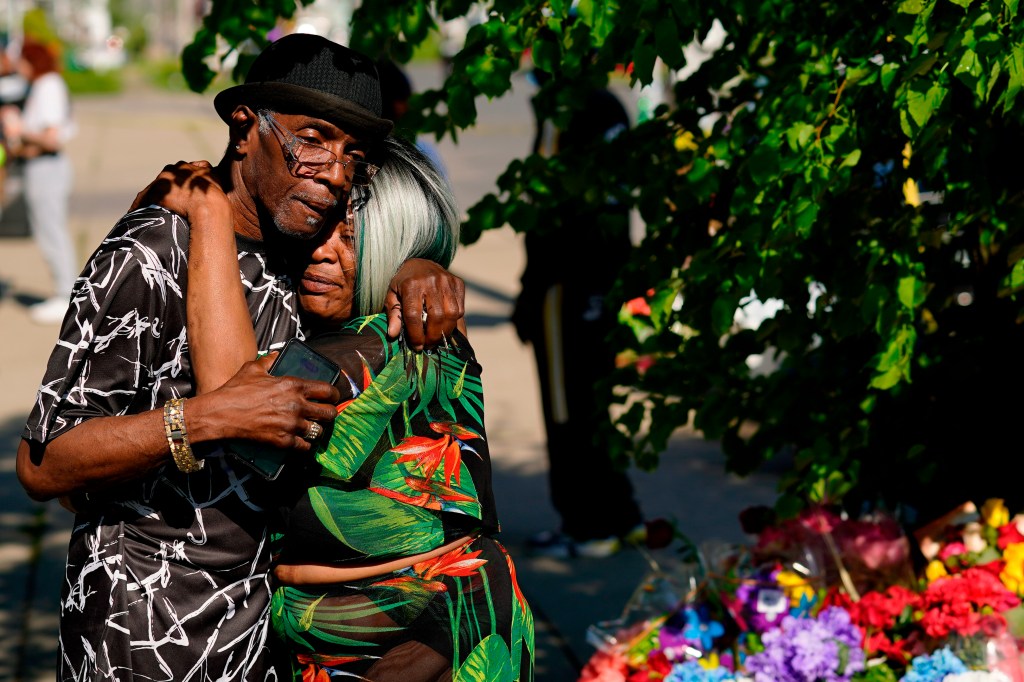 People embrace outside the scene of a shooting at a supermarket a day earlier, in Buffalo, N.Y., Sunday, May 15, 2022. (AP Photo/Matt Rourke)