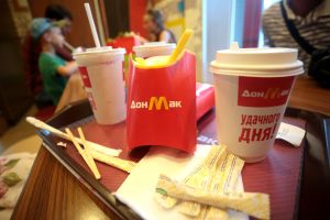 McDonalds look alike containers for fries and a coffee, with text in Russian.