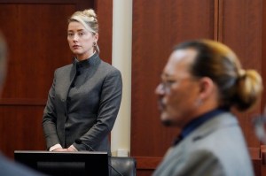 Actors Amber Heard and Johnny Depp watch as the jury leave the courtroom for a lunch break at the Fairfax County Circuit Courthouse in Fairfax, Va., Monday.