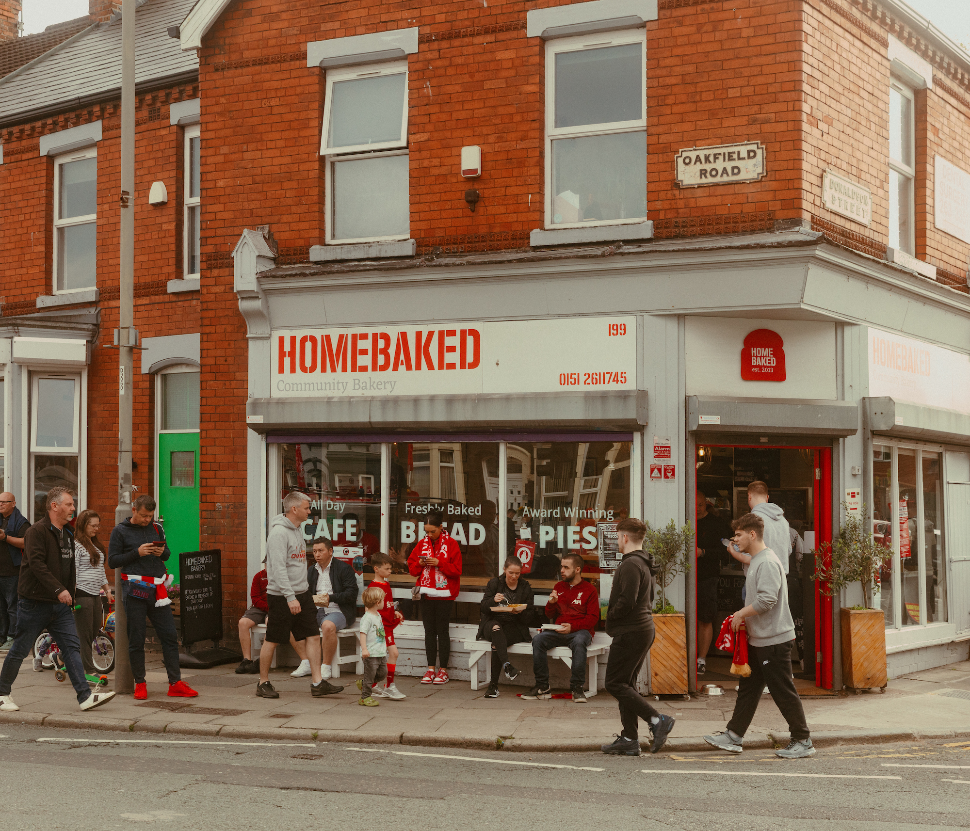 People eating food outside Homebaked Bakery in Liverpool.