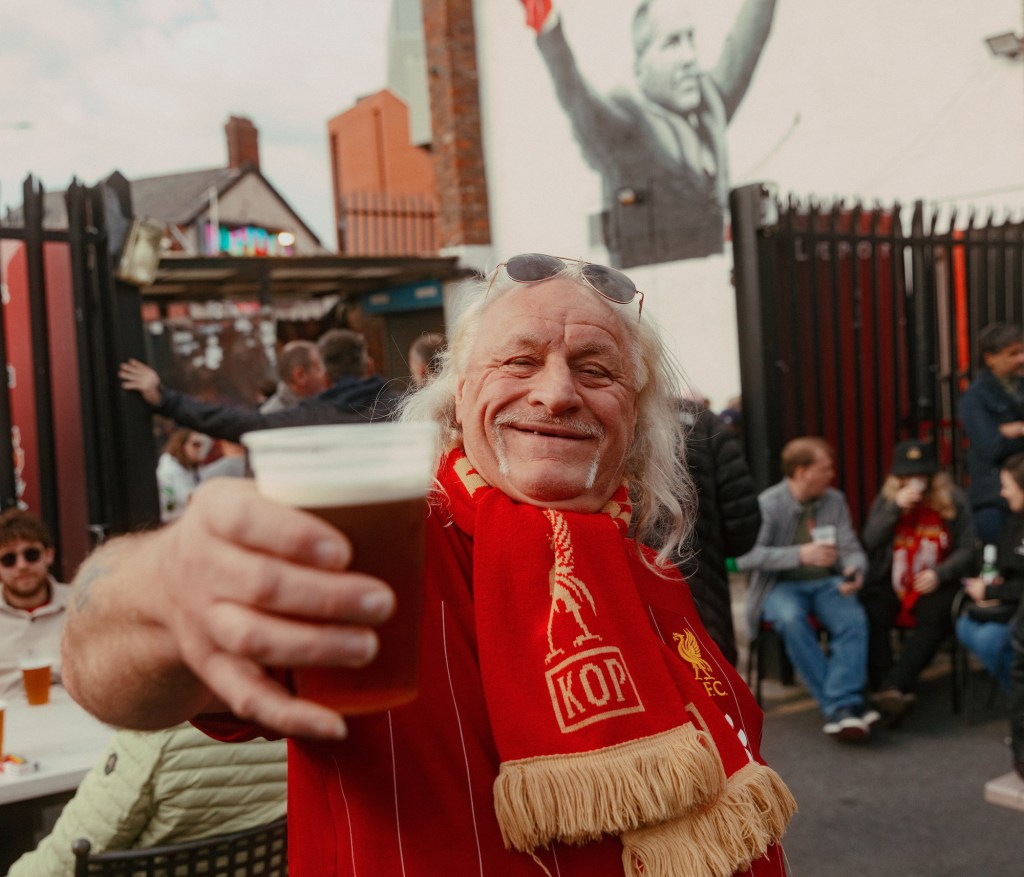 Friendly Liverpool supporter holding pint