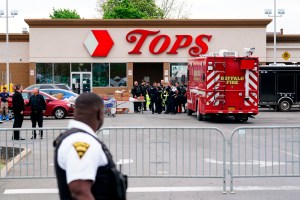 A police officer and fire truck outside the Tops Friendly market where an 18-year-old opened fire and killed 10 people and injured three others.