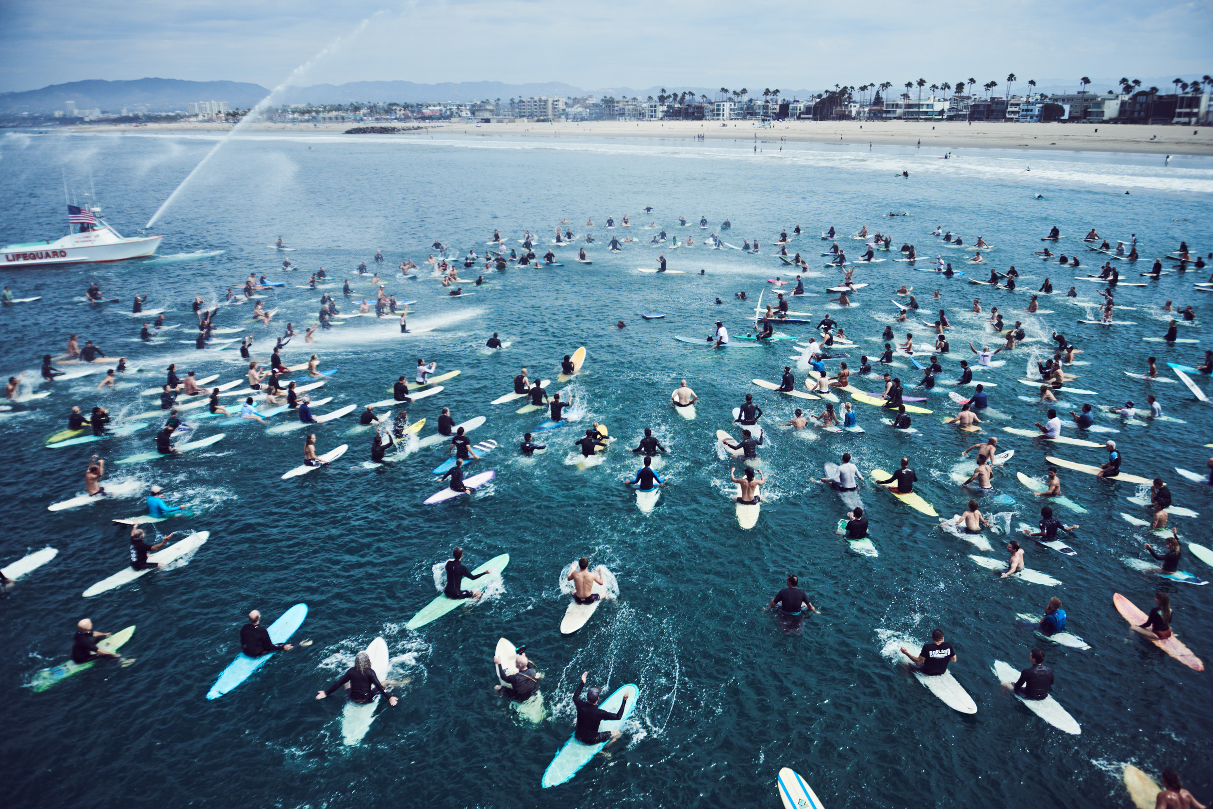 Surfers gather on the water for a surf funeral. Photo by Matthew Brookes, from Into the Wild, published by Damiani​