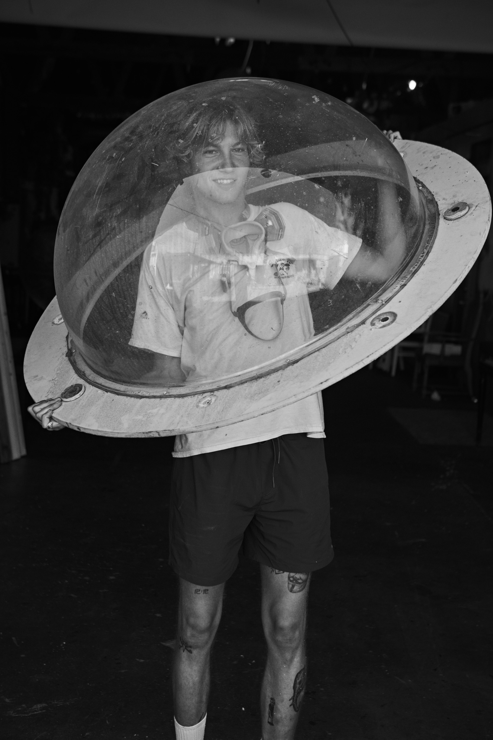 Venice Beach, California: A surfer holding up a dome. Photo by Matthew Brookes, from Into the Wild, published by Damiani​